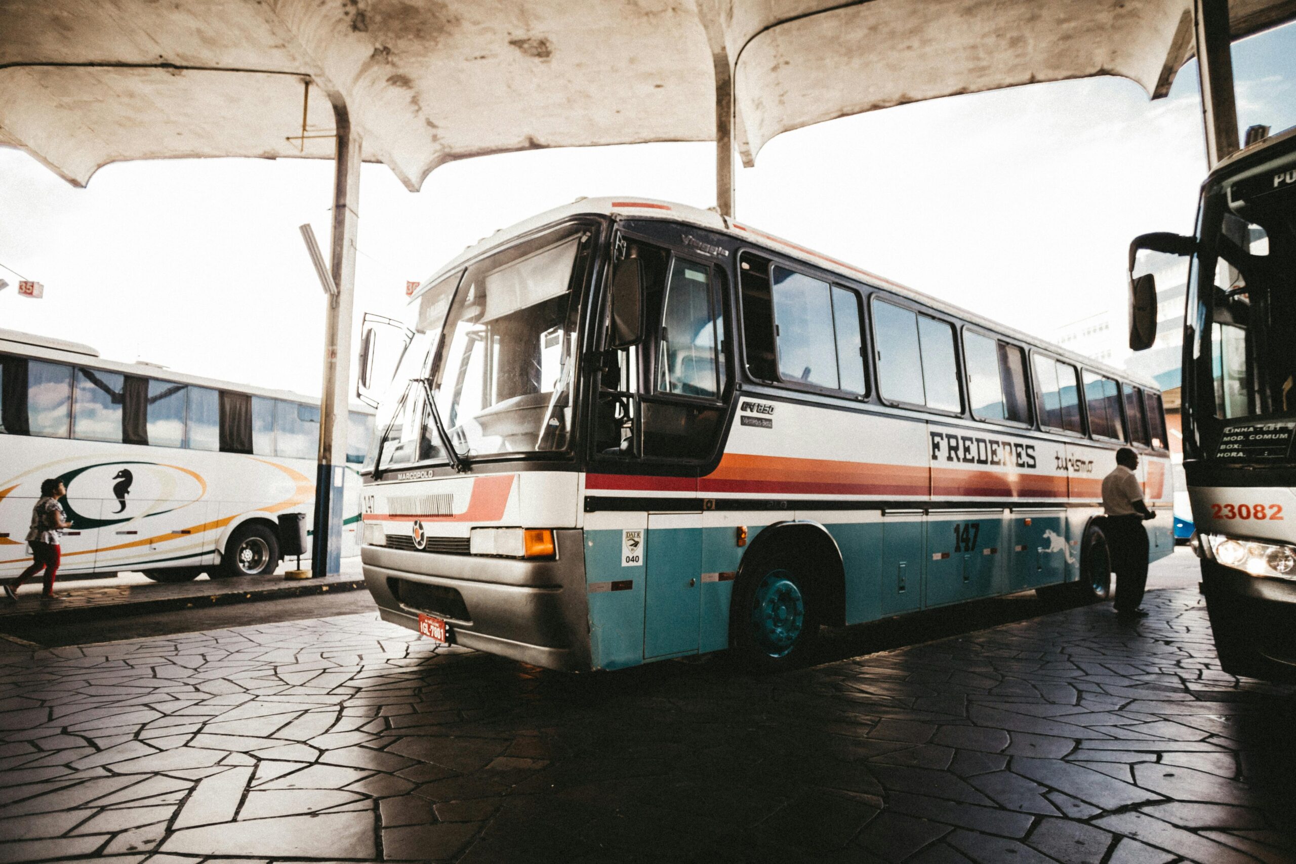 Colorful bus at an outdoor station captures transportation dynamics.